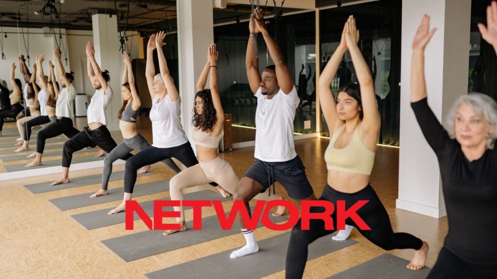 A diverse group working out together in a supportive fitness class
