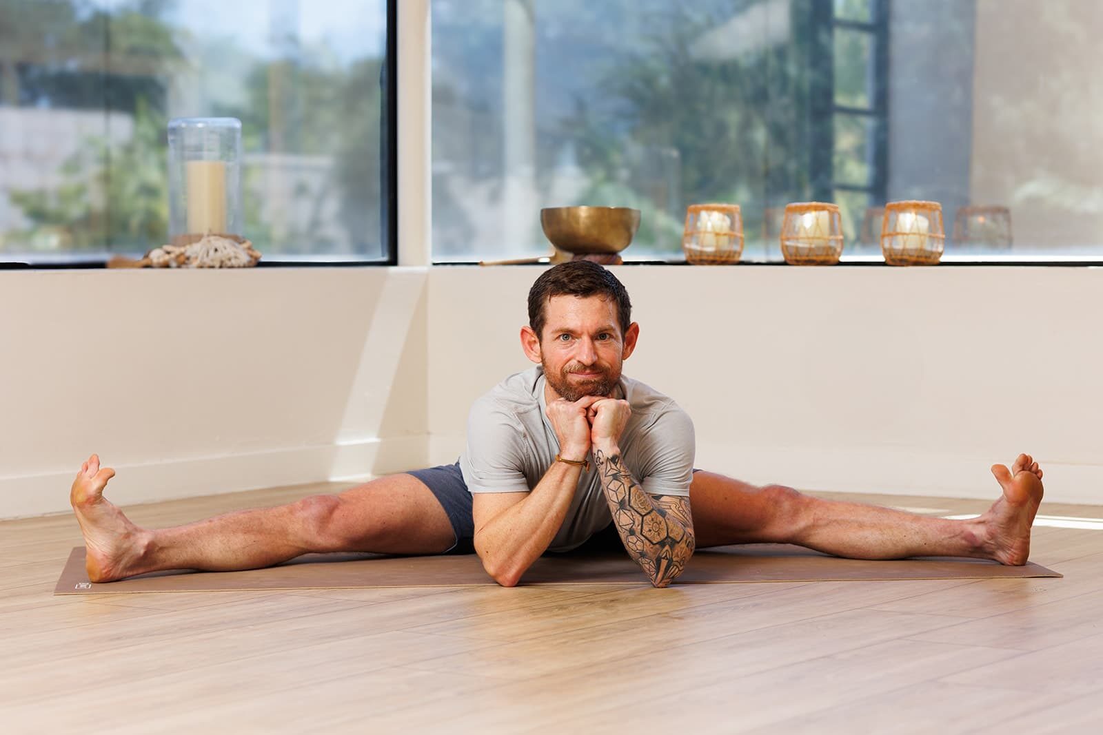 A person stretching in a sunlit gym, symbolizing the body as a temple